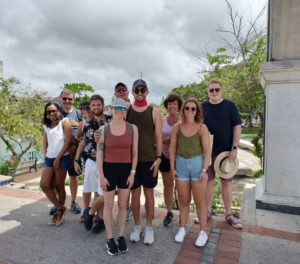 A group of guests, concluding the Bridgetown city tour with Chattel House Audio Tours, embraces the historic charm of Barbados